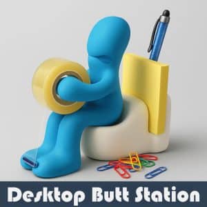 Square product image of the Butt Tape Dispenser featuring a blue cartoon figure sitting on a white toilet-shaped base, holding a roll of clear tape. The dispenser also includes a yellow sticky note holder, a glittery blue pen, and colorful paper clips scattered at its base. The words 'BUTT TAPE DISPENSER' appear in bold white text on a dark blue banner at the bottom."